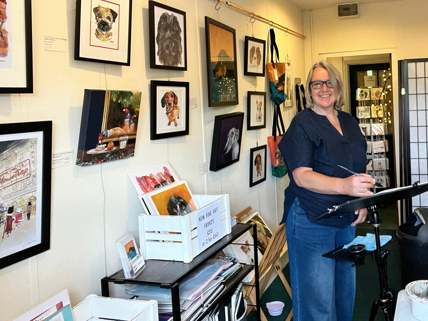 Award winning Artist Jo Scott Photographed in her Art Studio surrounded by framed artworks