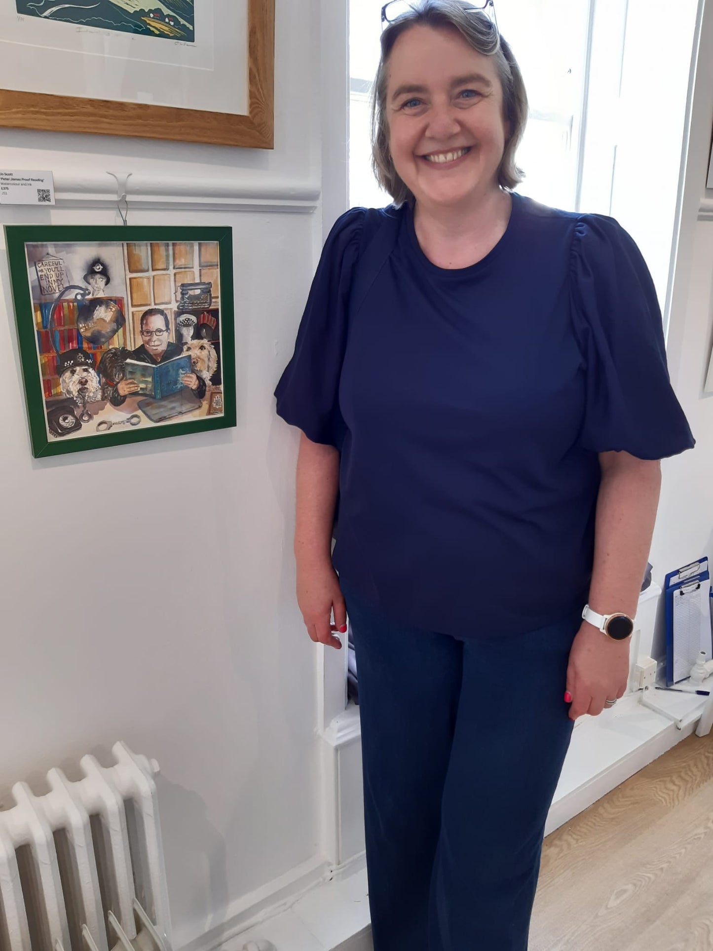 Artist Jo Scott photographed standing in an art gallery